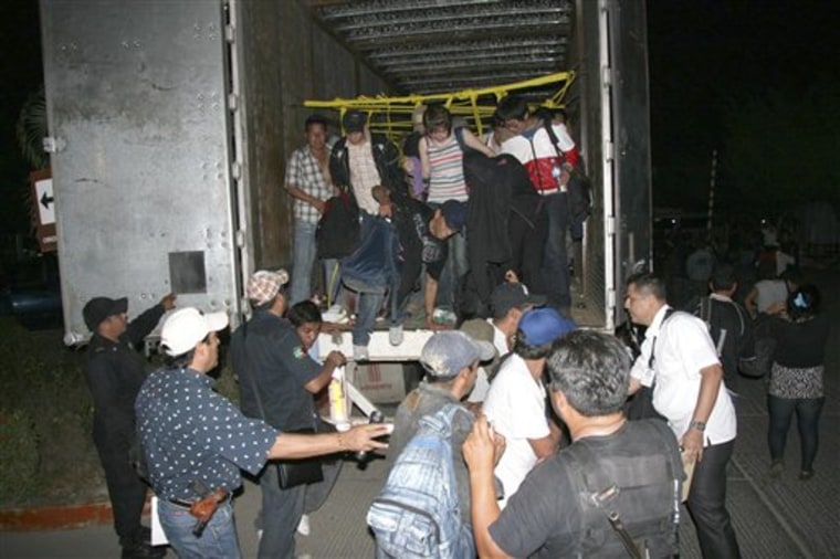 Migrants from Latin America and Asia leave a truck that was heading to the U.S. after being detected by an X-ray equipment near Tuxtla Gutierrez, in Mexico's southern Chiapas state, Tuesday.